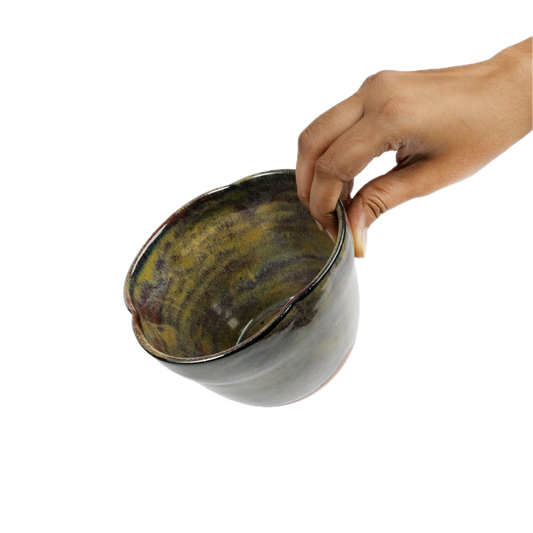 Iridescent bowl shown next to hand